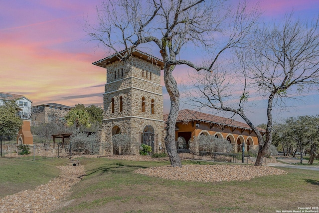 property at dusk with fence