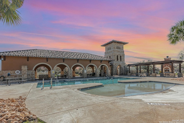 pool featuring a patio and a pergola