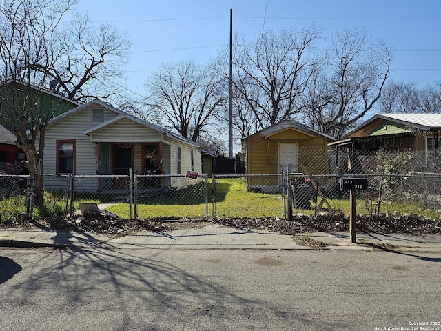 view of property exterior featuring a fenced front yard and a gate