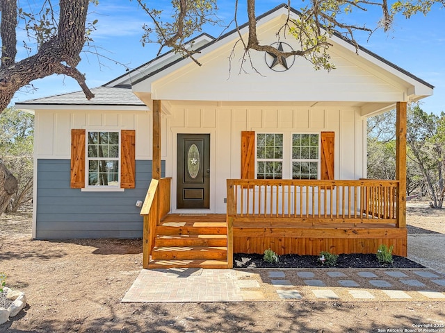 view of front of house featuring board and batten siding, a porch, and a shingled roof