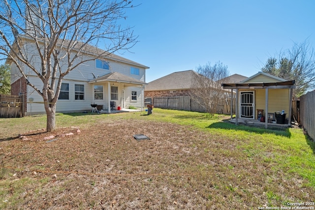 rear view of property with a patio area, a fenced backyard, and a lawn