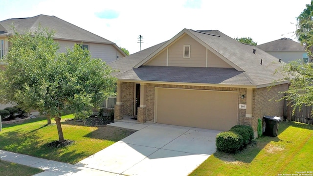 view of front facade featuring a front yard, concrete driveway, brick siding, and an attached garage