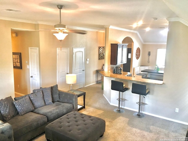 living room with baseboards, crown molding, visible vents, and carpet flooring