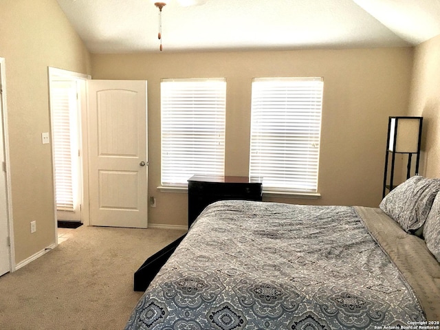 bedroom featuring lofted ceiling, carpet, and baseboards