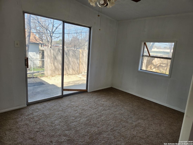 unfurnished room featuring carpet, a ceiling fan, and baseboards