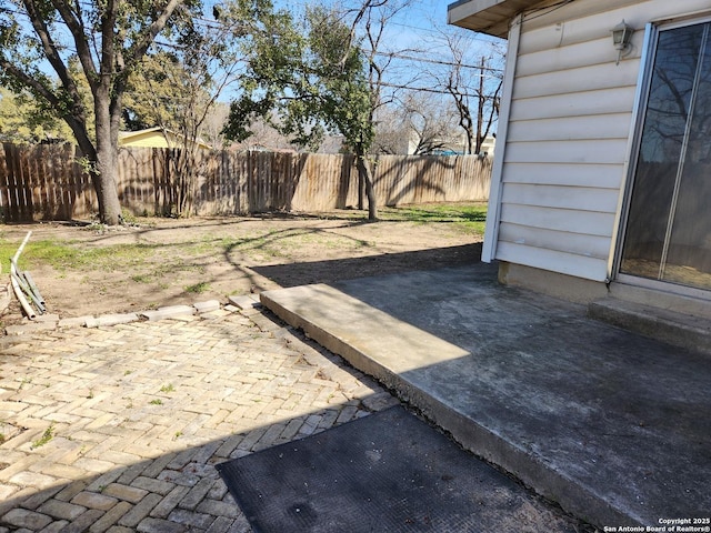 view of yard with fence and a patio