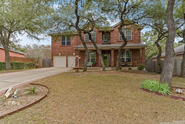 traditional-style house featuring a porch, an attached garage, brick siding, fence, and concrete driveway