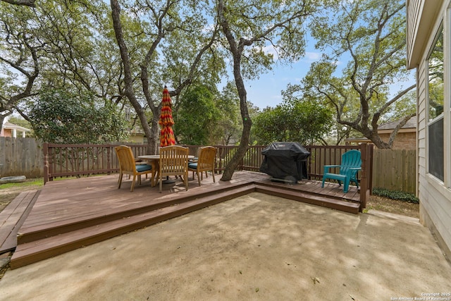 view of patio / terrace with a deck, outdoor dining space, grilling area, and fence private yard