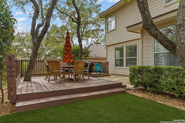 wooden deck with a lawn