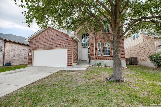 traditional home with brick siding, an attached garage, a front yard, entry steps, and driveway