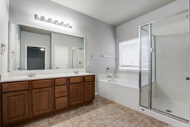 full bath featuring a garden tub, tile patterned flooring, a sink, a shower stall, and double vanity