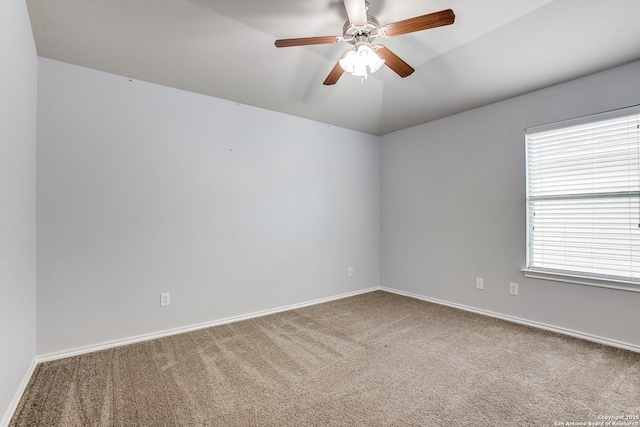 spare room featuring carpet floors, baseboards, and a ceiling fan