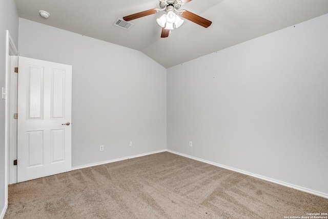 spare room featuring baseboards, visible vents, a ceiling fan, carpet, and vaulted ceiling