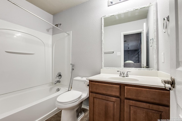 full bathroom with a textured wall, toilet, tile patterned floors, bathtub / shower combination, and vanity