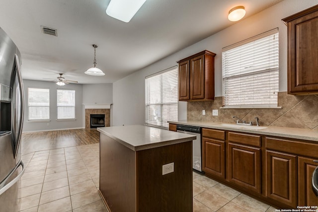 kitchen featuring light tile patterned floors, visible vents, appliances with stainless steel finishes, and a sink