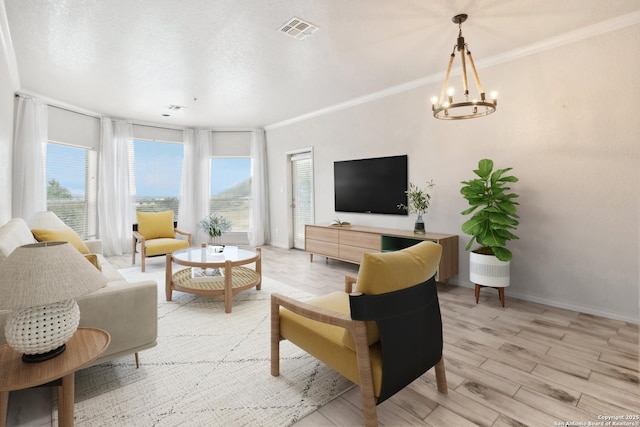 living room featuring light wood finished floors, visible vents, ornamental molding, a chandelier, and baseboards