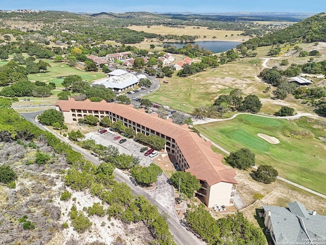 drone / aerial view featuring a water view and view of golf course