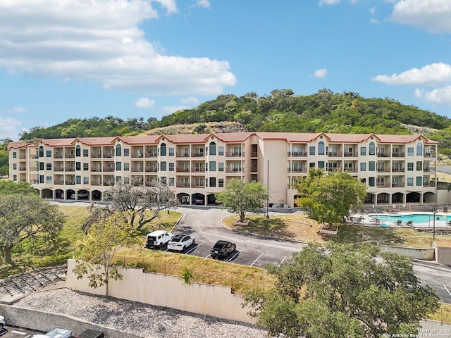 view of building exterior featuring uncovered parking