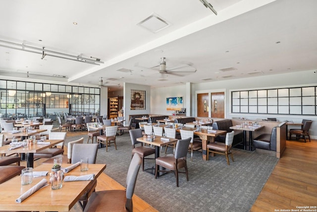 dining area featuring ceiling fan, visible vents, and wood finished floors