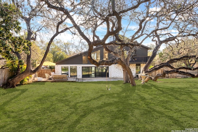 back of property featuring fence, a patio, and a yard