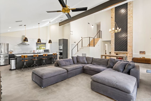 living area with beam ceiling, recessed lighting, stairway, high vaulted ceiling, and ceiling fan with notable chandelier