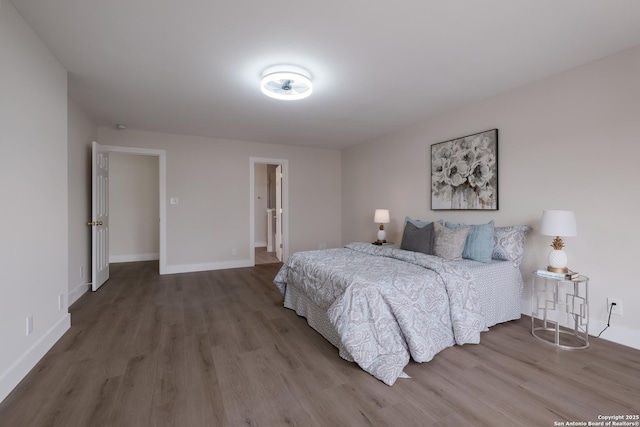 bedroom with baseboards and wood finished floors