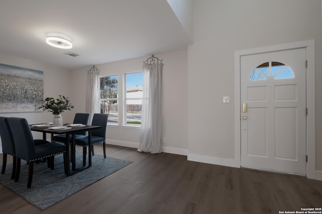 dining space featuring visible vents, baseboards, and wood finished floors