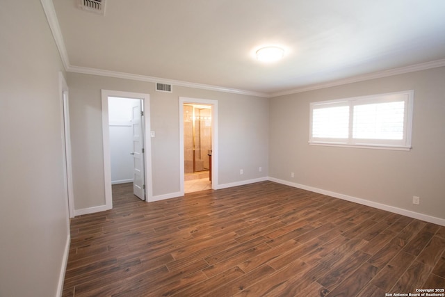 unfurnished bedroom featuring dark wood-style floors, visible vents, ornamental molding, and baseboards