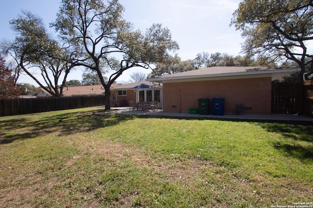 rear view of house featuring a patio area, fence, and a lawn