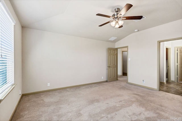 unfurnished bedroom with ceiling fan, baseboards, vaulted ceiling, and light colored carpet