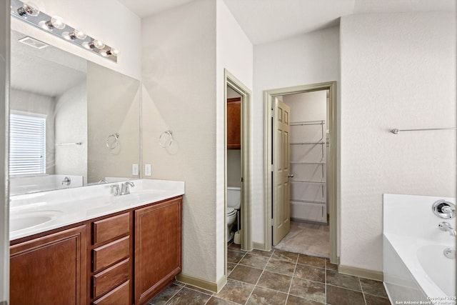 full bathroom with a garden tub, double vanity, visible vents, toilet, and a sink