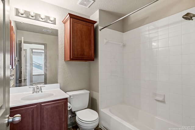 bathroom featuring bathtub / shower combination, visible vents, a textured wall, toilet, and a textured ceiling