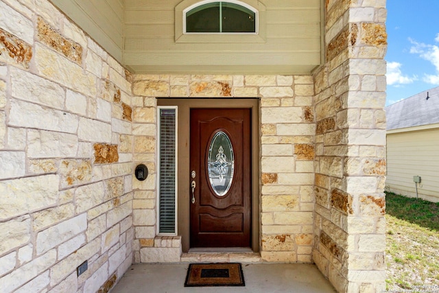 property entrance featuring stone siding