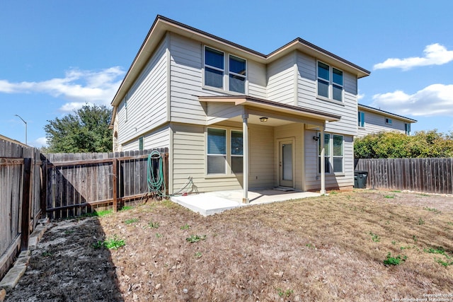 rear view of house featuring a patio area and a fenced backyard