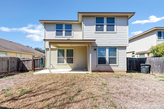 back of house with a yard, a patio area, and a fenced backyard