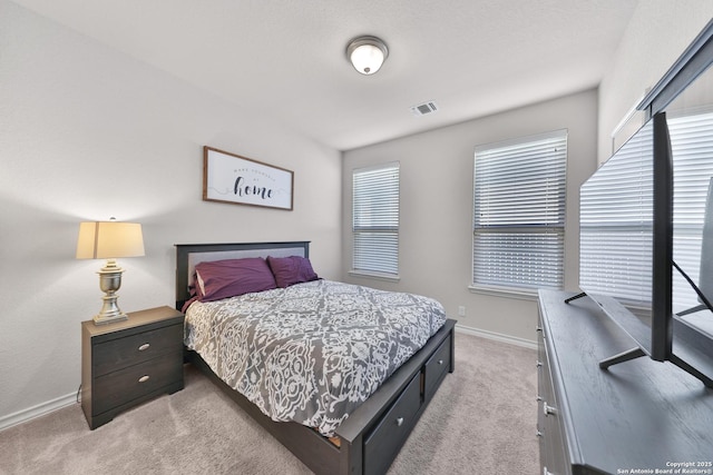 bedroom featuring light colored carpet, visible vents, and baseboards