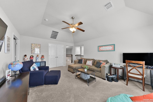 carpeted living area featuring lofted ceiling, visible vents, and a ceiling fan