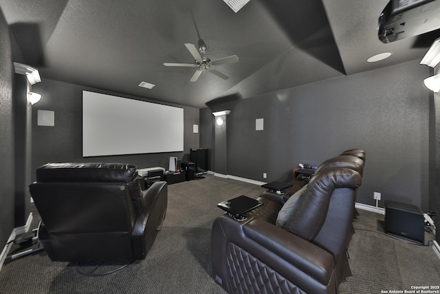 carpeted cinema featuring lofted ceiling, a textured ceiling, a ceiling fan, and baseboards