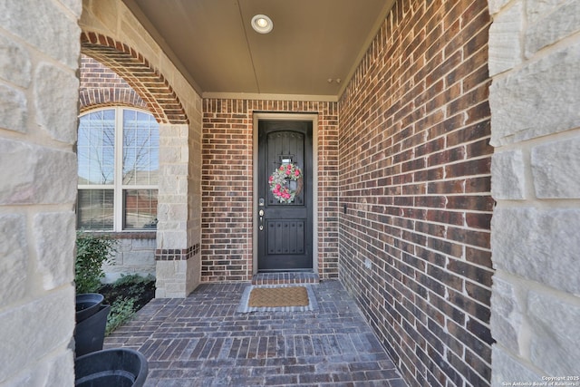 property entrance with brick siding