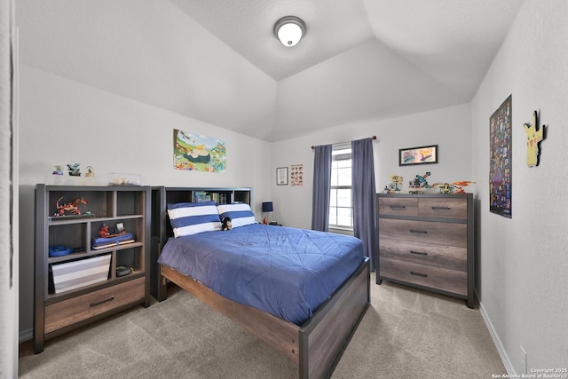 carpeted bedroom with lofted ceiling and baseboards