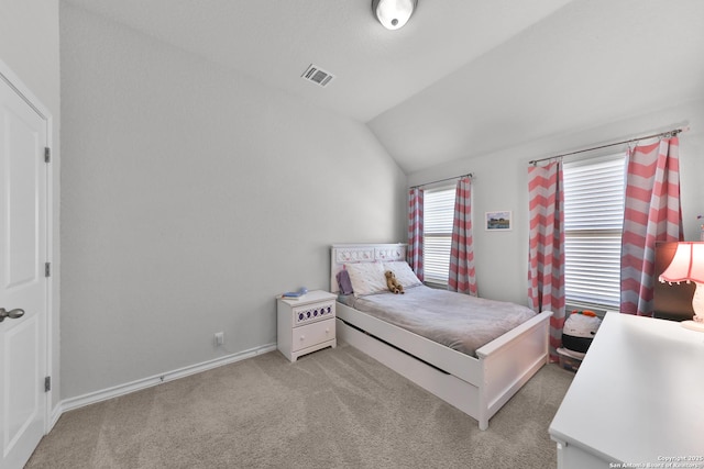 bedroom featuring lofted ceiling, baseboards, visible vents, and light colored carpet