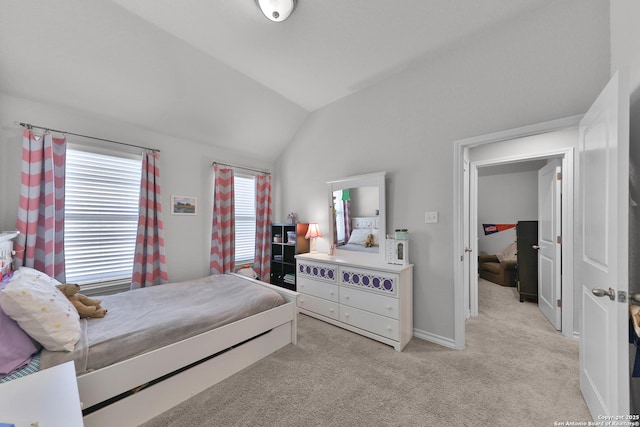 bedroom featuring lofted ceiling and light colored carpet