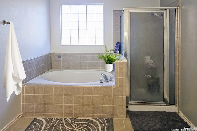 full bath featuring a garden tub, a shower stall, and tile patterned floors