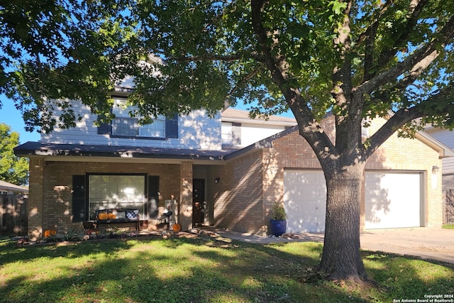 traditional home with a garage, brick siding, driveway, and a front lawn