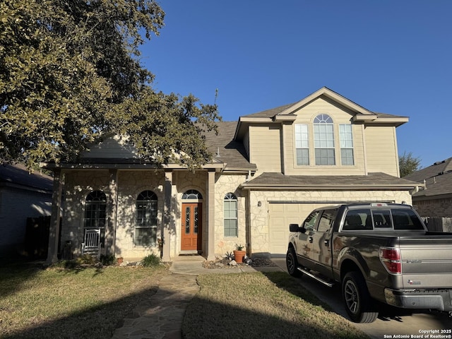 view of front of property featuring a garage and a front lawn