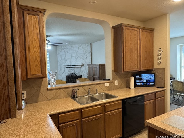 kitchen with a sink, decorative backsplash, dishwasher, and light countertops