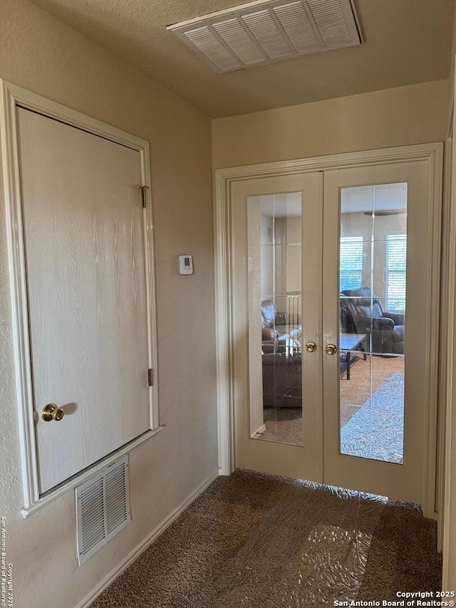 entryway featuring carpet, visible vents, and french doors