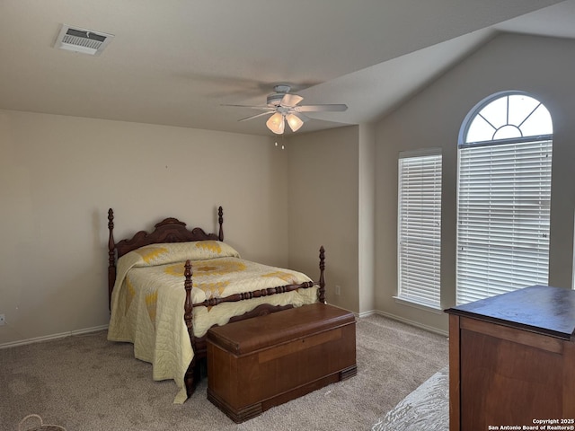 bedroom featuring light carpet, visible vents, baseboards, ceiling fan, and vaulted ceiling