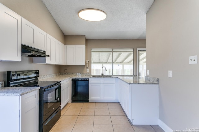 kitchen with black appliances, under cabinet range hood, a sink, and light tile patterned flooring