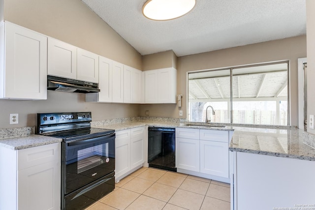 kitchen with black appliances, under cabinet range hood, white cabinets, and a sink